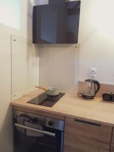 a kitchen with a stove with a bowl on it at Le Box Circuit Magny-Cours in Saint-Parize-le-Châtel