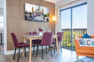 a dining room with a table and purple chairs at Lakeview 2 suites 6 min to New EPIC Universe in Orlando +61 photos