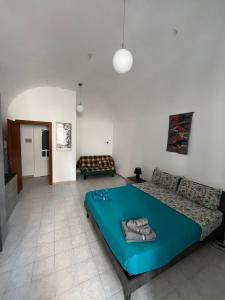 a bedroom with a large bed and a couch at Il campanile in Sulmona