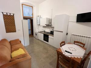 a living room with a couch and a table and a kitchen at Il campanile in Sulmona