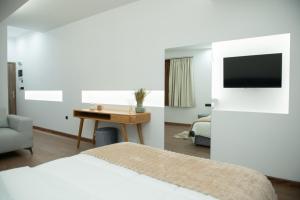 a hotel room with a bed and a desk and a tv at Klitiou 7 Boutique Hotel in Athens