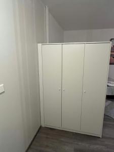a white closet with white cabinets in a room at Kumpukuja apartment in Kouvola