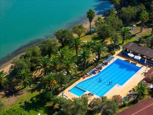 an aerial view of a swimming pool next to a beach at Blue Bay Apartment in Gouvia