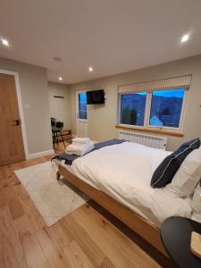 a bedroom with a large bed and a television at An Sealladh in Fort William