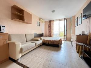a living room with a couch and a bed at Nessebar, Studio,South Beach, Larisa in Nesebar