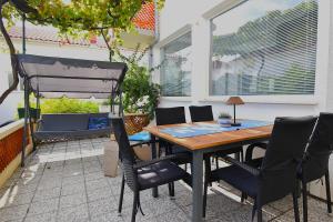 a patio with a table and chairs on a patio at Apartman Balen J. in Banjol