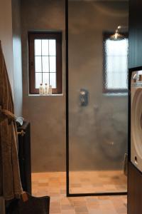 a shower with a glass door in a bathroom at Villa Ultima Thule in Ostend