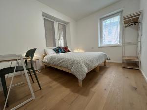a bedroom with a bed and a desk and a table at Casa Armadillo Guest Rooms in Trento