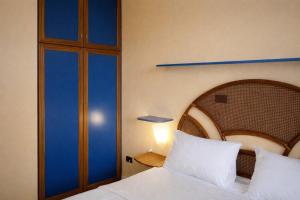 a bedroom with a bed with white pillows at Terrazza sul Mare Case Vacanze in Capo Rizzuto