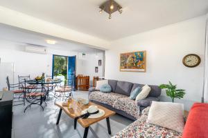 a living room with a couch and a table at Blue Bay Apartment in Gouvia