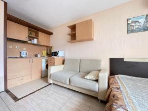a room with a bed and a couch and a kitchen at Nessebar, Studio,South Beach, Larisa in Nesebar