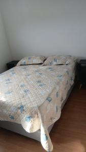 a bed with a comforter and pillows on it at Apartamento Cabedelo João Pessoa in Cabedelo +25 photos