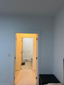 a hallway with a door leading to a bathroom at 2 Bedroom plus den 2 Bathroom apartment in Surrey +3 photos