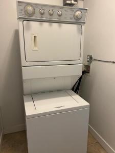 a white stove sitting in a kitchen next to a wall at 2 Bedroom plus den 2 Bathroom apartment in Surrey