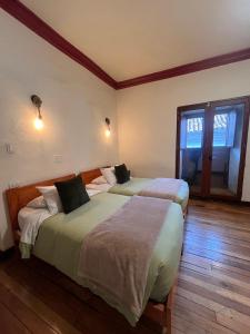 a bedroom with two beds in a room at Terra Sagrada Cusco in Cusco