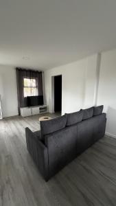 a large living room with a couch and a window at LN GuestHouse in Horta