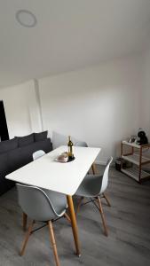 a white table and chairs in a living room at LN GuestHouse in Horta