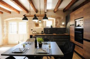 a kitchen with a table and chairs in a room at Villa Angelina - design stone house in Markovac in Višnjan
