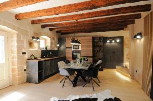 a kitchen and dining room with a table and chairs at Villa Angelina - design stone house in Markovac in Višnjan