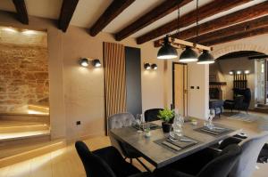 a dining room with a table and some chairs at Villa Angelina - design stone house in Markovac in Višnjan +31 photos