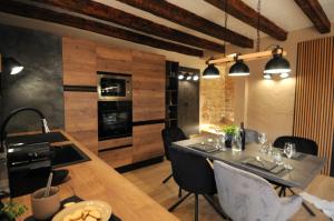 a kitchen and dining room with a table and chairs at Villa Angelina - design stone house in Markovac in Višnjan