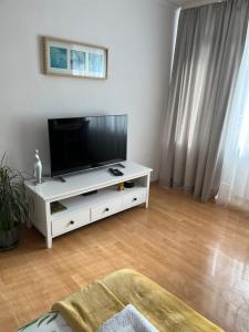 a living room with a flat screen tv on a white entertainment center at Apartament Korczaka możliwość wystawiania Faktur, WI-FI in Suwałki