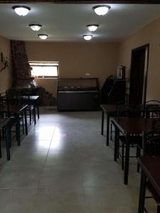a dining room with tables and chairs and lights at Elite House in Bakuriani