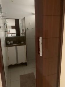 a bathroom with a sink and a mirror at Pousada e Hostel Praia do poço in Cabedelo +37 photos