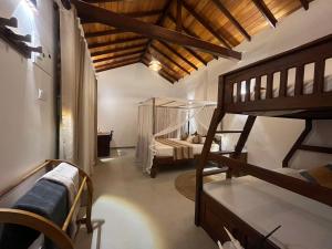 a room with a bunk bed and a bedroom with a loft at Beach Garden in Weligama