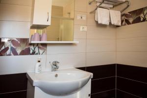 a bathroom with a white sink and a mirror at Hotel Pervan in Međugorje