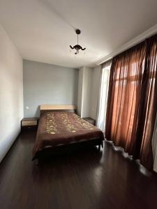 a bedroom with a bed and a window at Elite House in Bakuriani