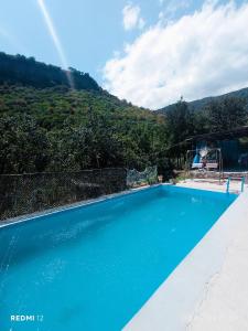 a swimming pool with a mountain in the background at Guest house VL in Alaverdi