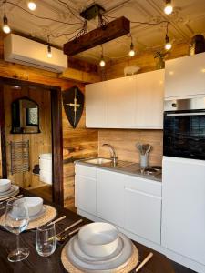 a kitchen with a table with plates on it at Willow Court Farm, The Copper Castle & Petting Farm, 8 min to Legoland & Windsor, 15 min to Lapland UK in Windsor