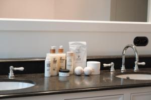 a bathroom counter with two sinks and toiletries at Villa Ultima Thule in Ostend +21 photos