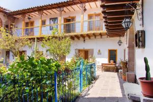 a house with a fence and a balcony at Terra Sagrada Cusco in Cusco