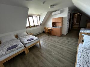 a dorm room with two beds and a kitchen at Penzion U Ježka in Nedakonitz +14 photos