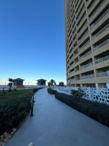 a walkway in front of a large apartment building at Front Front Water in Ain Sokhna
