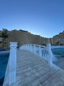 a wooden walkway next to a swimming pool at Front Front Water in Ain Sokhna
