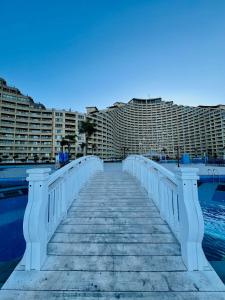 a bridge over the water with buildings in the background at Front Front Water in Ain Sokhna