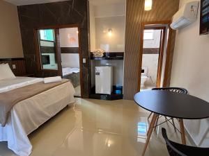 a bedroom with a bed and a table and a small table at Pousada Estalagem Da Serra in Serra do Cipo +147 photos