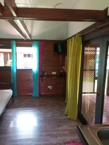 a room with colorful curtains in a room at Raiatea Airport Bungalow in Uturoa