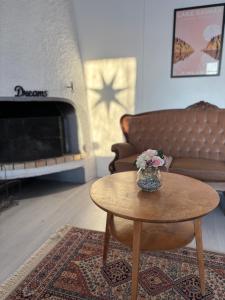 a living room with a coffee table and a couch at Villa Saimaan Sydän in Puumala