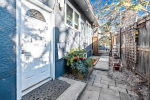 an entrance to a house with a white door and plants at Bright & Cozy Central Retreat in Calgary
