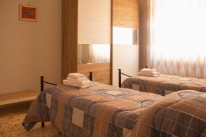 a room with two beds with towels on them at vivaldi casa vacanza in Caserta
