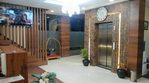 an office lobby with a clock on the wall at Hotel Singh Empire in Sāgar