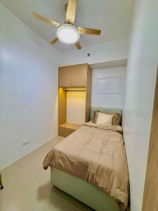 a bedroom with a bed and a ceiling fan at Golden Maison de Luxe in Manila +4 photos