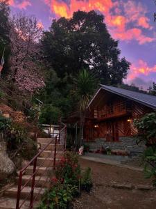 a house with a staircase leading up to it at Tamu Kyi Retreat in Kaluk