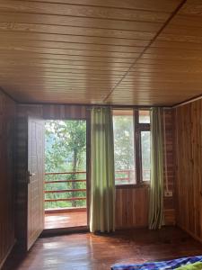 an empty room with a door and a window at Tamu Kyi Retreat in Kaluk +21 photos