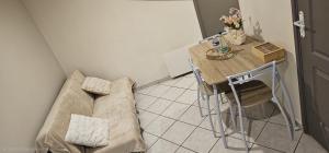a small room with a table and a couch at Studio 33 m2 a saint Michel de Maurienne in Saint-Michel-de-Maurienne