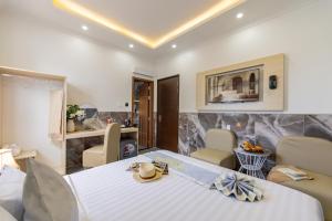 a room with a bed and a table and chairs at Nghia Lan Maison - DL Center in Da Lat